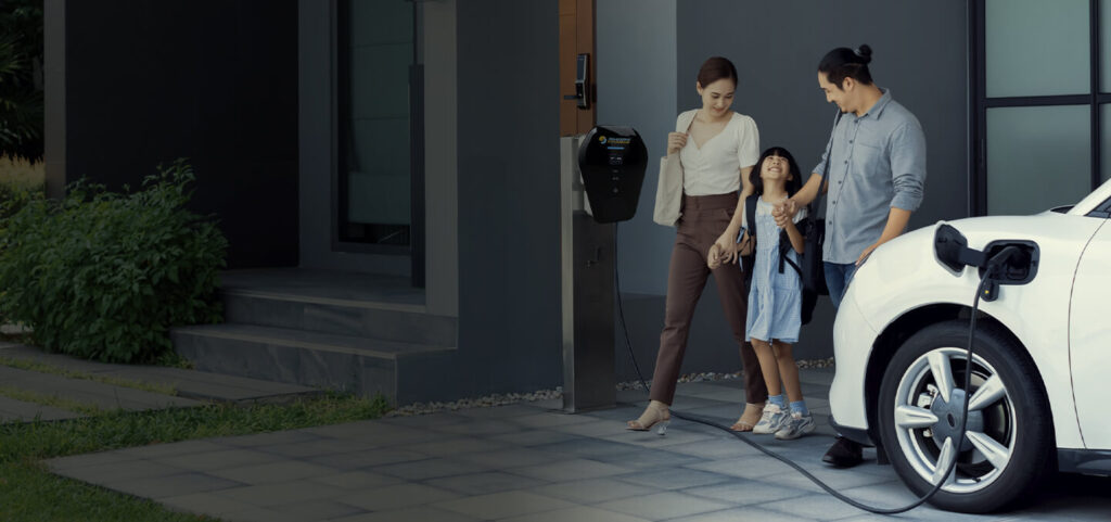 a family entering a home while their electric vehicle charges